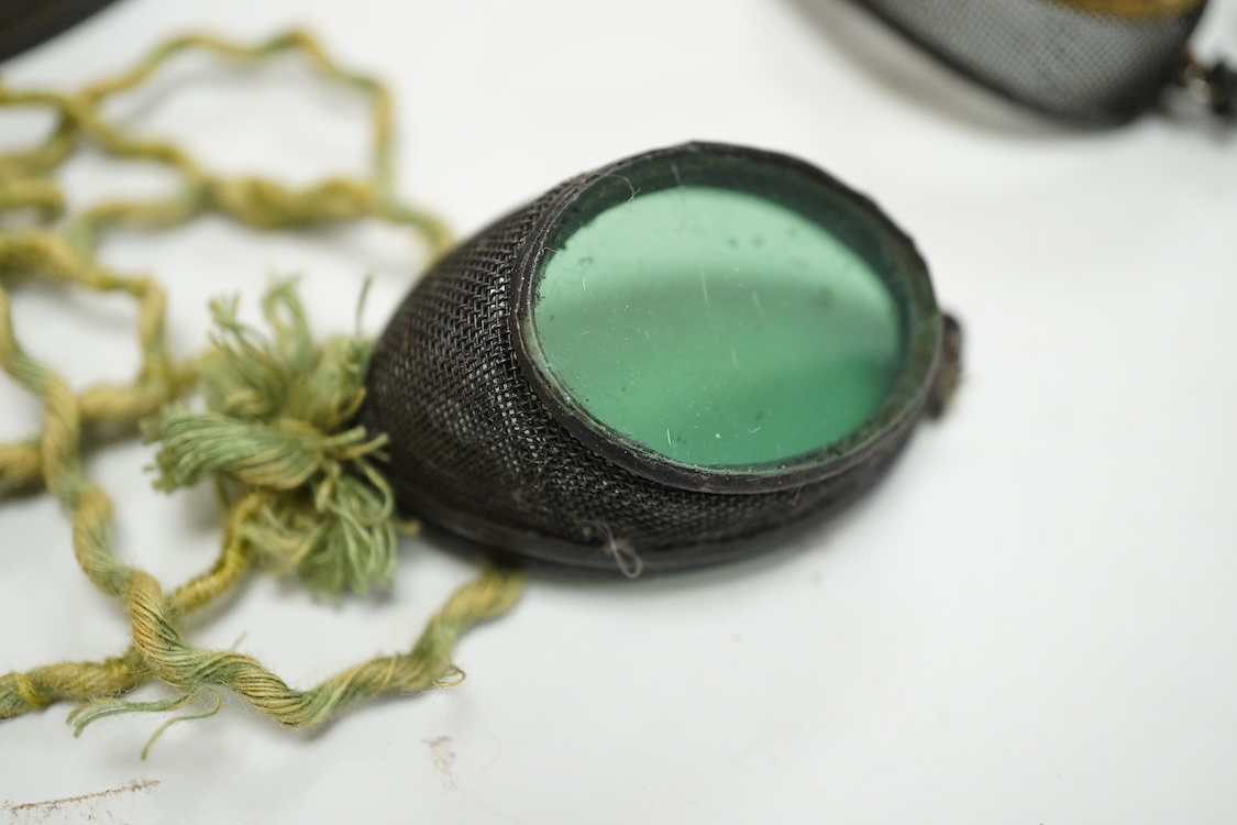 Five pairs of early 20th century goggles with mesh side protectors, two pairs colour tinted, in original tin boxes and two pairs of mesh eye protectors (7)